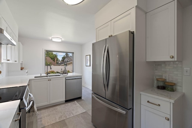 818 W 27th Ave, Spokane, WA 99203 - kitchen featuring stainless steel appliances, light countertops, white cabinets, and decorative backsplash