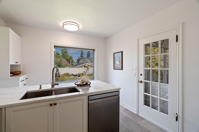 818 W 27th Ave, Spokane, WA 99203 - kitchen with dishwasher, white cabinetry, light stone counters, and wood finished floors