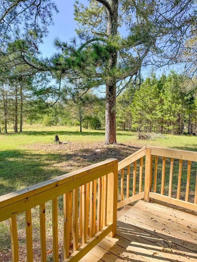 wooden deck featuring a yard