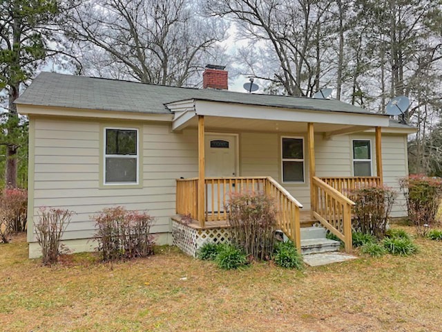 bungalow-style house with a front yard