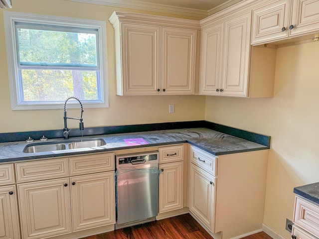 kitchen with sink, dark stone countertops, stainless steel dishwasher, cream cabinets, and dark wood-type flooring