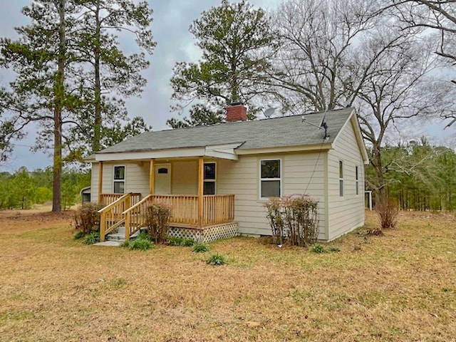 view of front of home with a front yard and a deck