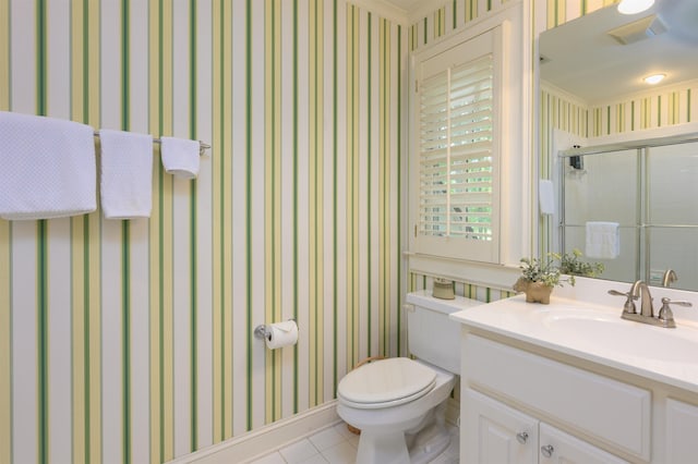 bathroom with tile patterned flooring, vanity, an enclosed shower, and toilet