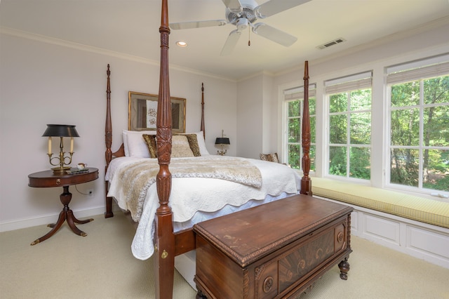 bedroom featuring multiple windows, crown molding, light carpet, and ceiling fan