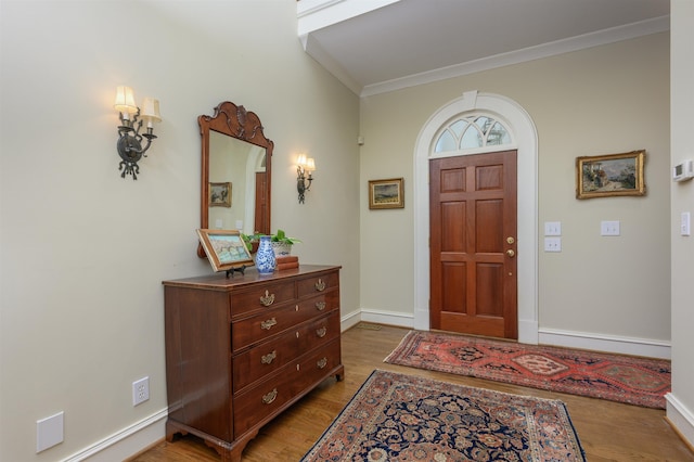 entryway featuring crown molding and light wood-type flooring