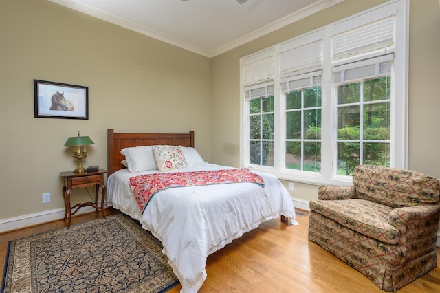 bedroom featuring crown molding and light wood-type flooring