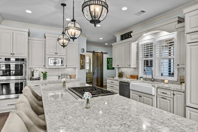 1611 Lighthouse Cir, Greensboro, GA 30642 - kitchen with a sink, a barn door, light stone countertops, appliances with stainless steel finishes, and ornamental molding