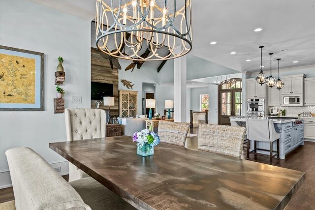 1611 Lighthouse Cir, Greensboro, GA 30642 - dining space featuring a notable chandelier, crown molding, high vaulted ceiling, dark wood-style floors, and recessed lighting
