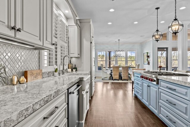 1611 Lighthouse Cir, Greensboro, GA 30642 - kitchen with decorative light fixtures, stainless steel appliances, dark wood-type flooring, backsplash, and a notable chandelier