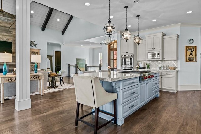 1611 Lighthouse Cir, Greensboro, GA 30642 - kitchen with stainless steel appliances, dark wood finished floors, decorative backsplash, a kitchen island, and white cabinets