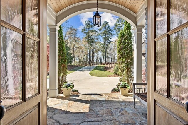 1611 Lighthouse Cir, Greensboro, GA 30642 - doorway with vaulted ceiling, ornamental molding, stone tile flooring, and a chandelier
