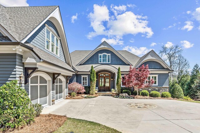 1611 Lighthouse Cir, Greensboro, GA 30642 - view of front of home featuring driveway, a garage, french doors, and roof with shingles