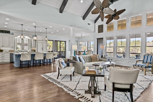 1611 Lighthouse Cir, Greensboro, GA 30642 - living room featuring dark wood-style flooring, high vaulted ceiling, beamed ceiling, ceiling fan with notable chandelier, and wood ceiling