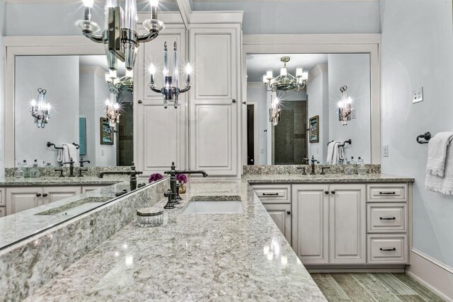 1611 Lighthouse Cir, Greensboro, GA 30642 - full bath with an inviting chandelier, wood finish floors, a shower stall, a sink, and two vanities