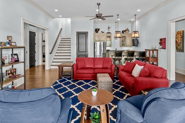 1611 Lighthouse Cir, Greensboro, GA 30642 - living area with ceiling fan, ornamental molding, stairs, and wood finished floors
