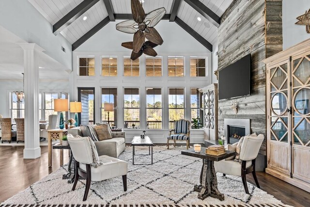 1611 Lighthouse Cir, Greensboro, GA 30642 - living area featuring a large fireplace, wood finished floors, ceiling fan, and decorative columns