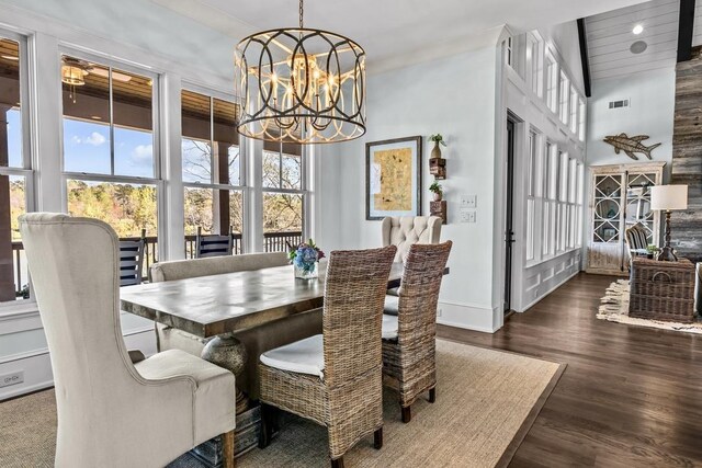 1611 Lighthouse Cir, Greensboro, GA 30642 - dining area with a high ceiling, wood finished floors, baseboards, visible vents, and an inviting chandelier