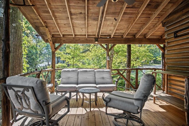 wooden terrace with ceiling fan and outdoor lounge area