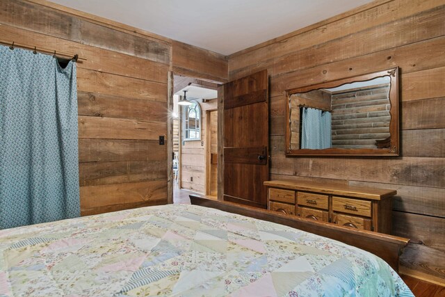 unfurnished bedroom with wood walls