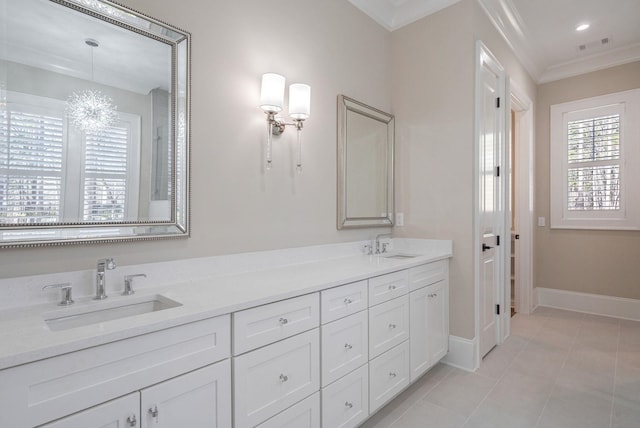 bathroom featuring ornamental molding, tile patterned flooring, a sink, and baseboards