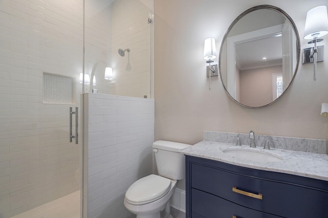 bathroom featuring a stall shower, vanity, and toilet