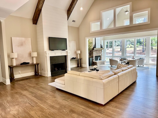1180 Maple Ridge Way, Greensboro, GA 30642 - living area with a fireplace, baseboards, beamed ceiling, and wood finished floors