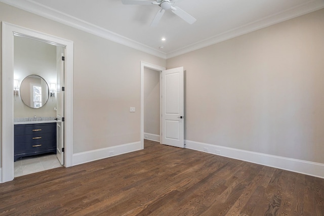 unfurnished bedroom featuring ornamental molding, a ceiling fan, connected bathroom, wood finished floors, and baseboards