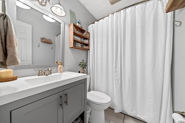 full bath with curtained shower, a textured ceiling, toilet, and vanity