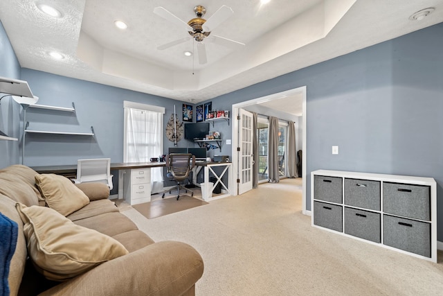 office with carpet, recessed lighting, ceiling fan, a textured ceiling, and a raised ceiling