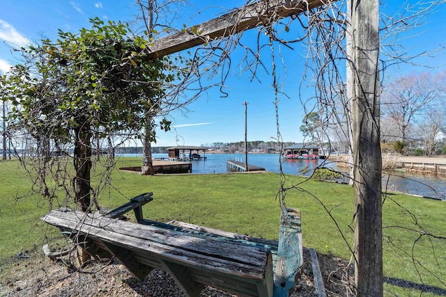 view of yard featuring a boat dock and a water view