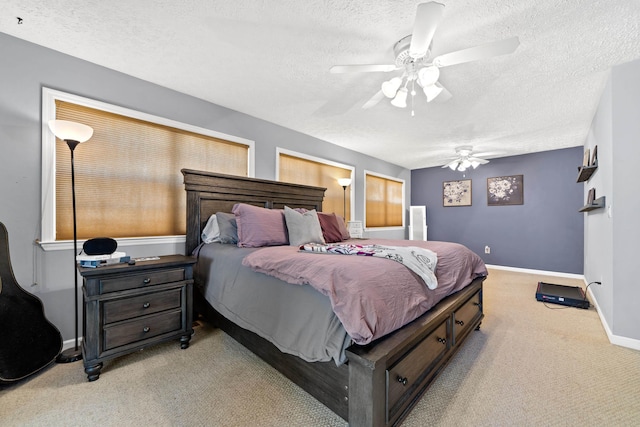 bedroom with baseboards, carpet floors, a textured ceiling, and a ceiling fan