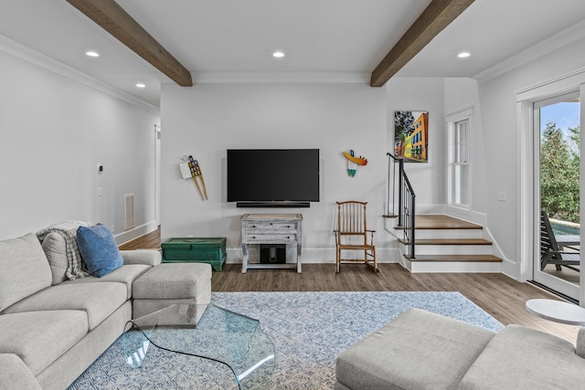 living room featuring beamed ceiling, crown molding, and hardwood / wood-style flooring