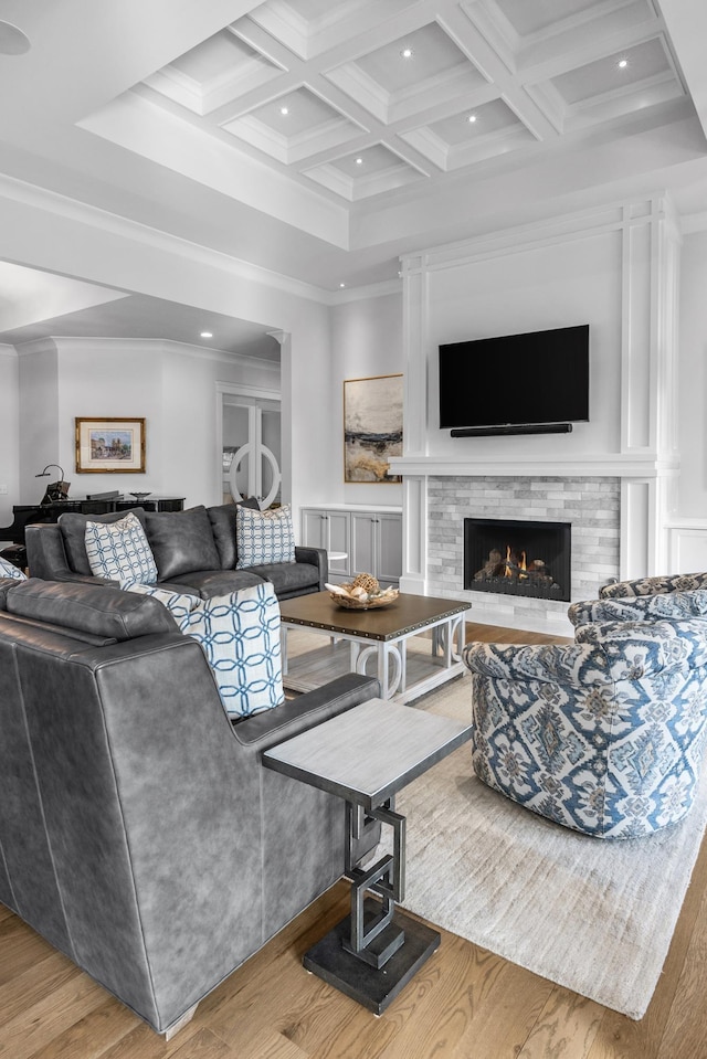 living room with coffered ceiling, crown molding, light hardwood / wood-style flooring, and beamed ceiling