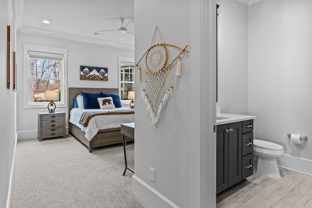 bedroom with crown molding and light colored carpet