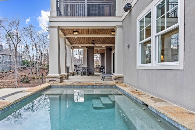 view of swimming pool featuring ceiling fan and a patio area