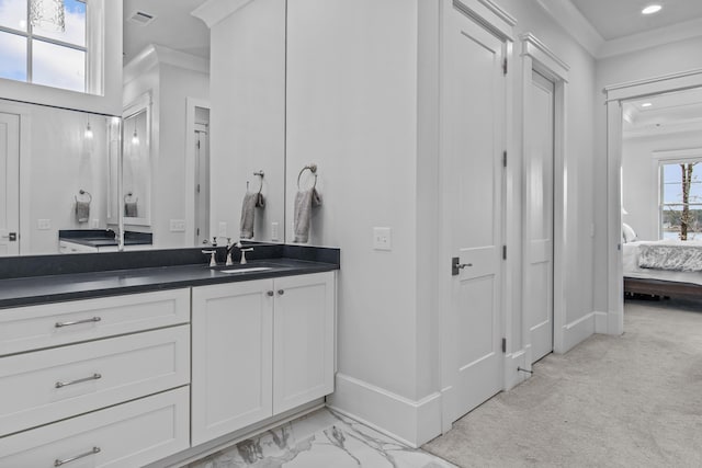 bathroom featuring ornamental molding and vanity