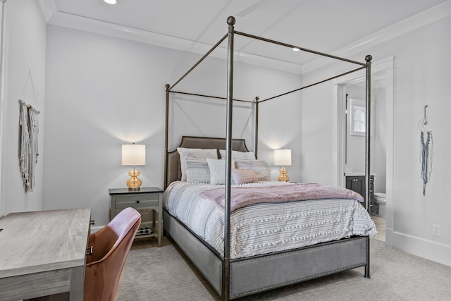 bedroom featuring ensuite bath and carpet flooring