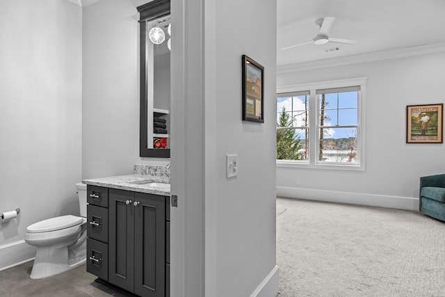 bathroom featuring crown molding, ceiling fan, vanity, and toilet