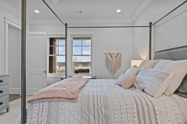 bedroom featuring hardwood / wood-style floors and ornamental molding