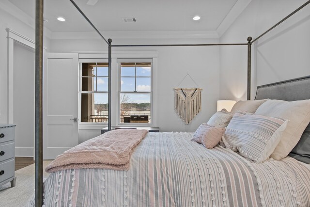 bedroom featuring hardwood / wood-style floors and ornamental molding