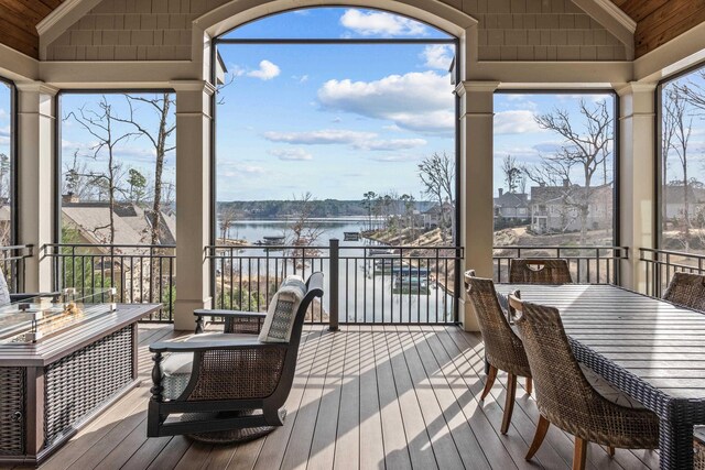 wooden terrace featuring a water view