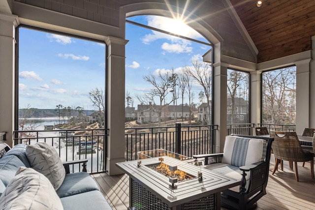 sunroom featuring vaulted ceiling, a water view, and wooden ceiling