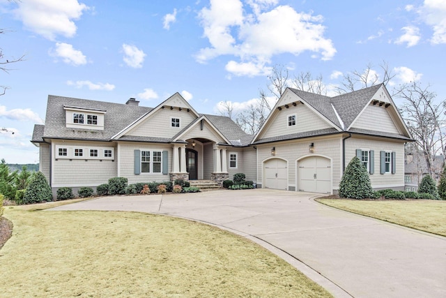 view of front of home featuring a garage and a front yard