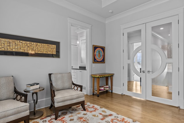 sitting room featuring light hardwood / wood-style floors and french doors