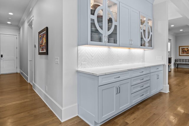 hallway with dark hardwood / wood-style flooring and crown molding