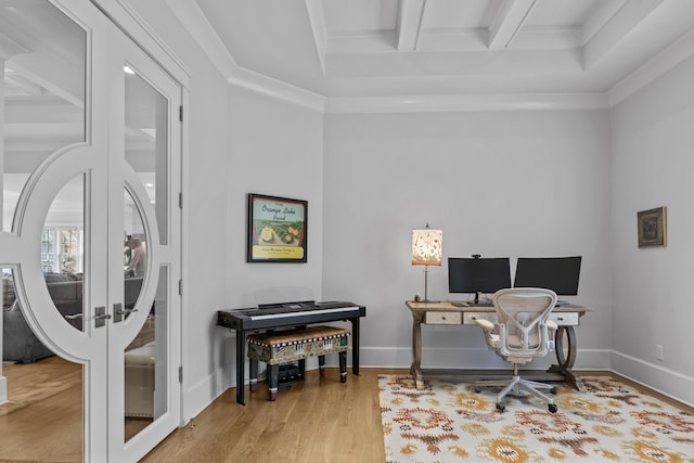 office featuring french doors, beamed ceiling, ornamental molding, and light wood-type flooring