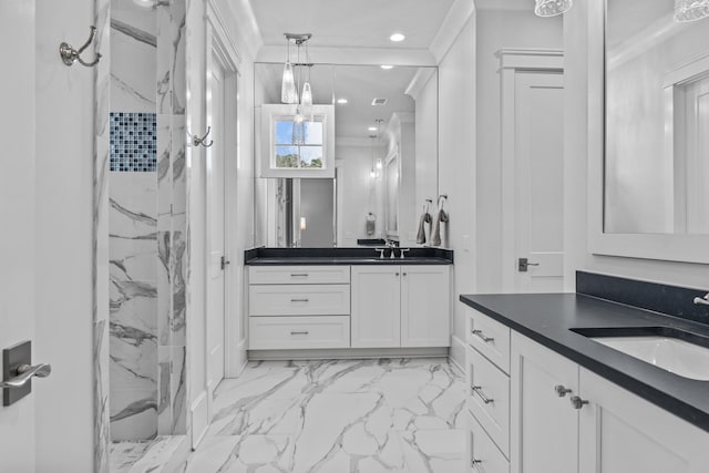 bathroom with crown molding, vanity, and a tile shower