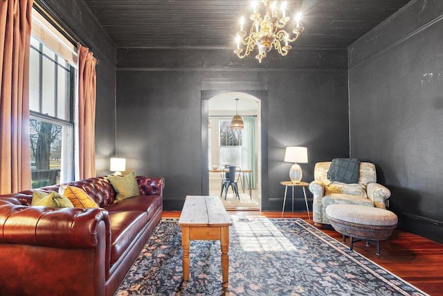 living room featuring hardwood / wood-style flooring and an inviting chandelier