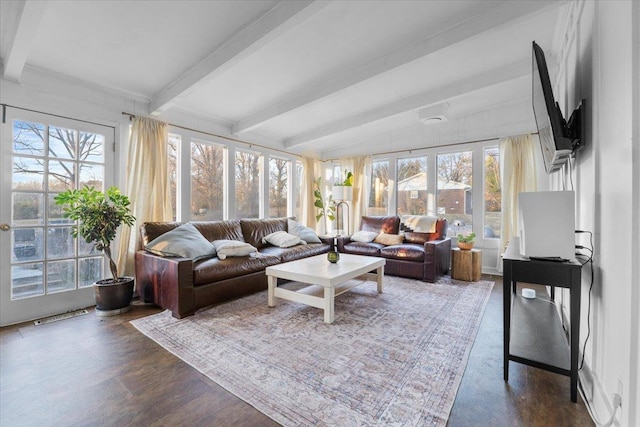 sunroom featuring beam ceiling