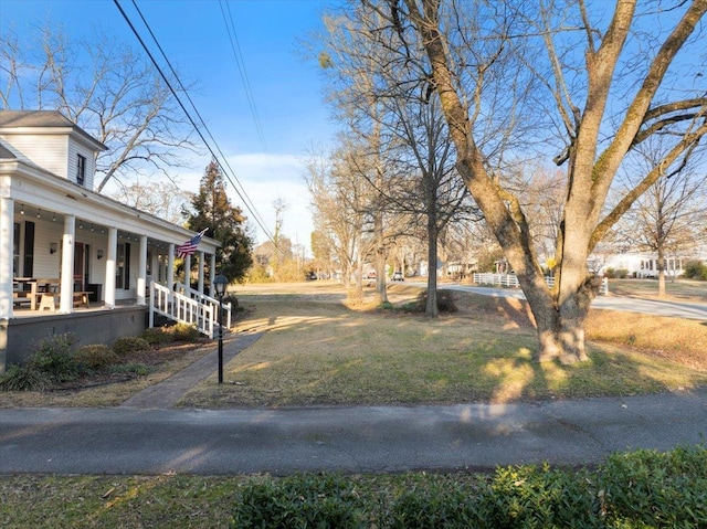 view of yard with covered porch